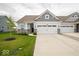 Charming home with a two-car garage, beautifully landscaped yard, and stone accents at 9455 Orchard Cove Dr, Indianapolis, IN 46239