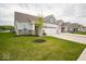 Charming home with a two-car garage, lush green lawn, and beautiful landscaping at 9455 Orchard Cove Dr, Indianapolis, IN 46239