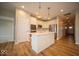Bright kitchen featuring hardwood floors, white cabinets, stainless appliances, and kitchen island at 9455 Orchard Cove Dr, Indianapolis, IN 46239