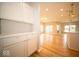 Open-concept kitchen featuring hardwood floors, white cabinets, and stainless-steel appliances at 9455 Orchard Cove Dr, Indianapolis, IN 46239