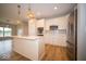 Modern kitchen featuring hardwood floors, white cabinets, a kitchen island, and recessed lighting at 9455 Orchard Cove Dr, Indianapolis, IN 46239