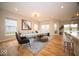 Bright living room featuring hardwood floors, large windows, modern furniture, and recessed lighting at 9455 Orchard Cove Dr, Indianapolis, IN 46239