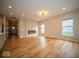 Spacious living room featuring hardwood floors, recessed lighting, and a modern fireplace at 9455 Orchard Cove Dr, Indianapolis, IN 46239