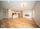 Open-concept living area featuring hardwood floors, recessed lighting, and a modern fireplace at 9455 Orchard Cove Dr, Indianapolis, IN 46239