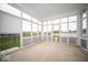 Sunroom featuring lake view through expansive windows and sliding doors at 9455 Orchard Cove Dr, Indianapolis, IN 46239