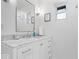 Modern bathroom featuring sleek white cabinets, marble countertop, and bright natural light at 9944 Holaday Dr, Carmel, IN 46032