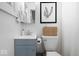 Stylish bathroom with a blue vanity, woven basket, and botanical wall art at 9944 Holaday Dr, Carmel, IN 46032