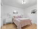 Bright bedroom with two windows and a cozy pink patterned quilt at 9944 Holaday Dr, Carmel, IN 46032