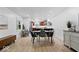 Bright dining room featuring hardwood flooring, modern furnishings, and neutral paint at 9944 Holaday Dr, Carmel, IN 46032
