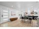 Open dining room with light wood floors that flows into a modern kitchen space at 9944 Holaday Dr, Carmel, IN 46032
