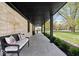 Inviting front porch showcases comfortable bench seating, tile flooring, and stone exterior at 9944 Holaday Dr, Carmel, IN 46032