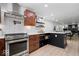 Open kitchen with stainless appliances, granite countertops, and white subway tile at 9944 Holaday Dr, Carmel, IN 46032