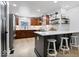 Modern kitchen featuring stainless steel appliances, a breakfast bar, and wood cabinets at 9944 Holaday Dr, Carmel, IN 46032