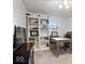 Home office with built-in shelves, desk, and neutral decor at 9944 Holaday Dr, Carmel, IN 46032