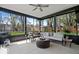 Inviting sunroom with outdoor views, comfortable seating, and a ceiling fan for year-round enjoyment at 9944 Holaday Dr, Carmel, IN 46032