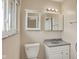 Bathroom featuring a sink, mirror, vanity, and lighting fixtures at 1043 E Castle Ave, Indianapolis, IN 46227