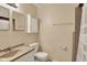 Neutral bathroom features a sink, toilet, and enclosed cabinet for storage at 1043 E Castle Ave, Indianapolis, IN 46227