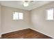 Cozy bedroom featuring hardwood floors, neutral paint, and a ceiling fan at 1043 E Castle Ave, Indianapolis, IN 46227