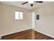 Bedroom with hardwood floors, a ceiling fan, and view of a doorway at 1043 E Castle Ave, Indianapolis, IN 46227
