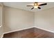 Cozy bedroom showcasing hardwood floors and a ceiling fan at 1043 E Castle Ave, Indianapolis, IN 46227