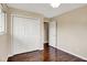 Bedroom featuring hardwood floors and white closet doors at 1043 E Castle Ave, Indianapolis, IN 46227