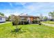Inviting single-story brick home with fresh green lawn and mature tree at 1043 E Castle Ave, Indianapolis, IN 46227