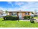 Charming brick ranch with tidy landscaping and a well-manicured front yard at 1043 E Castle Ave, Indianapolis, IN 46227
