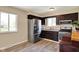 Stylish kitchen with stainless steel refrigerator and ample cabinet space at 1043 E Castle Ave, Indianapolis, IN 46227