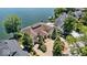 Beautiful aerial shot of luxury lakefront home with mature trees and private driveway at 10919 Brigantine Dr, Indianapolis, IN 46256