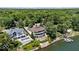 Aerial view of a lakefront estate with manicured gardens and a private dock at 10919 Brigantine Dr, Indianapolis, IN 46256
