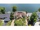 Stunning aerial view of a lakefront home with lush landscaping and a private dock at 10919 Brigantine Dr, Indianapolis, IN 46256