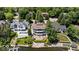 Aerial view of a large lakefront home with well-manicured landscaping and a private pool at 10919 Brigantine Dr, Indianapolis, IN 46256