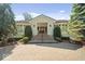 Elegant home entrance with a brick driveway, manicured shrubs and a classic door at 10919 Brigantine Dr, Indianapolis, IN 46256