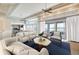 Staged living room with plenty of natural light and open to the kitchen with modern decor at 10919 Brigantine Dr, Indianapolis, IN 46256