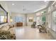 Bright living room with neutral tile, large windows with shutters, and traditional style furnishings at 10919 Brigantine Dr, Indianapolis, IN 46256