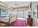 Comfortable bedroom with tray ceilings, neutral walls, and multiple windows with lovely water views at 10919 Brigantine Dr, Indianapolis, IN 46256