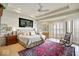 Bright bedroom featuring tray ceilings, large windows, and a comfortable rug accenting the tiled floor at 10919 Brigantine Dr, Indianapolis, IN 46256