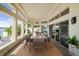 Stylish enclosed patio boasts a large dining table and great views through large windows at 10919 Brigantine Dr, Indianapolis, IN 46256