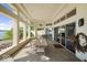 Enclosed patio with beautiful views features tile floors and elegant columns and ample seating at 10919 Brigantine Dr, Indianapolis, IN 46256