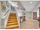 Open staircase leading to the upper floor with wood steps, metal railing and a convenient lower level wet bar at 10919 Brigantine Dr, Indianapolis, IN 46256