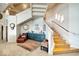 Well lit staircase with wood steps and metal railing, leading to a lower level landing with seating at 10919 Brigantine Dr, Indianapolis, IN 46256