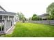 Large grassy backyard perfect for outdoor activities, with a playset and fenced perimeter at 10982 Gate Cir, Fishers, IN 46038