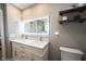 Bright bathroom featuring a double sink vanity, illuminated mirror, and stylish shelving for an elegant and functional space at 10982 Gate Cir, Fishers, IN 46038