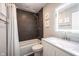 Updated bathroom with dark tiled shower, modern vanity, and decorative mirror at 10982 Gate Cir, Fishers, IN 46038