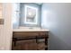Modern bathroom with a wooden vanity, quartz countertop, LED mirror, and storage at 10982 Gate Cir, Fishers, IN 46038