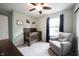 Comfortable bedroom featuring neutral walls, a ceiling fan, and a glider near the window, perfect for relaxing at 10982 Gate Cir, Fishers, IN 46038