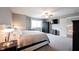 Bright bedroom featuring a ceiling fan, mounted TV, dresser, and large window for natural light at 10982 Gate Cir, Fishers, IN 46038