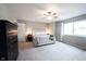 Spacious bedroom with carpet, fan, dresser, nightstands, and natural light from a large window at 10982 Gate Cir, Fishers, IN 46038