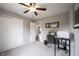 Bedroom with gray carpet and walls featuring a workstation desk and sliding door closet, offering a functional space at 10982 Gate Cir, Fishers, IN 46038