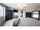 Well-lit bedroom with black dressers, carpet flooring, ceiling fan, and neutral walls at 10982 Gate Cir, Fishers, IN 46038